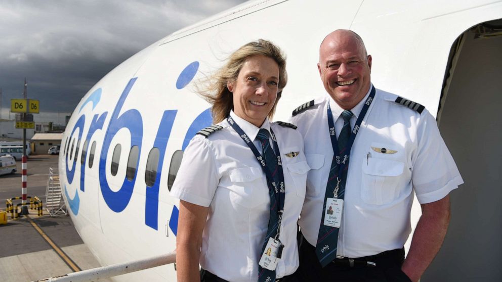 PHOTO: Peter and Cheryl Pitzer pose together outside an Orbis plane.