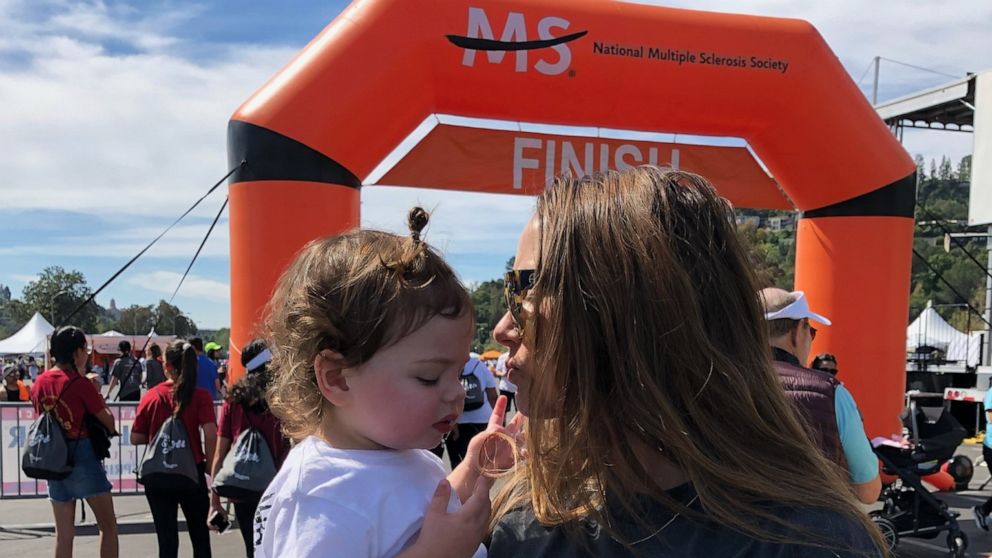PHOTO: Sarah Wolfe, 37, holds her child at a National MS Society walk in the Los Angeles area.