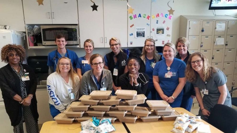 PHOTO: Hospital workers in Charleston, South Carolina, pose with food donated through an initiative started by Whitney Klomparens, Suzi Pigg and Leigh Ann Garrett.