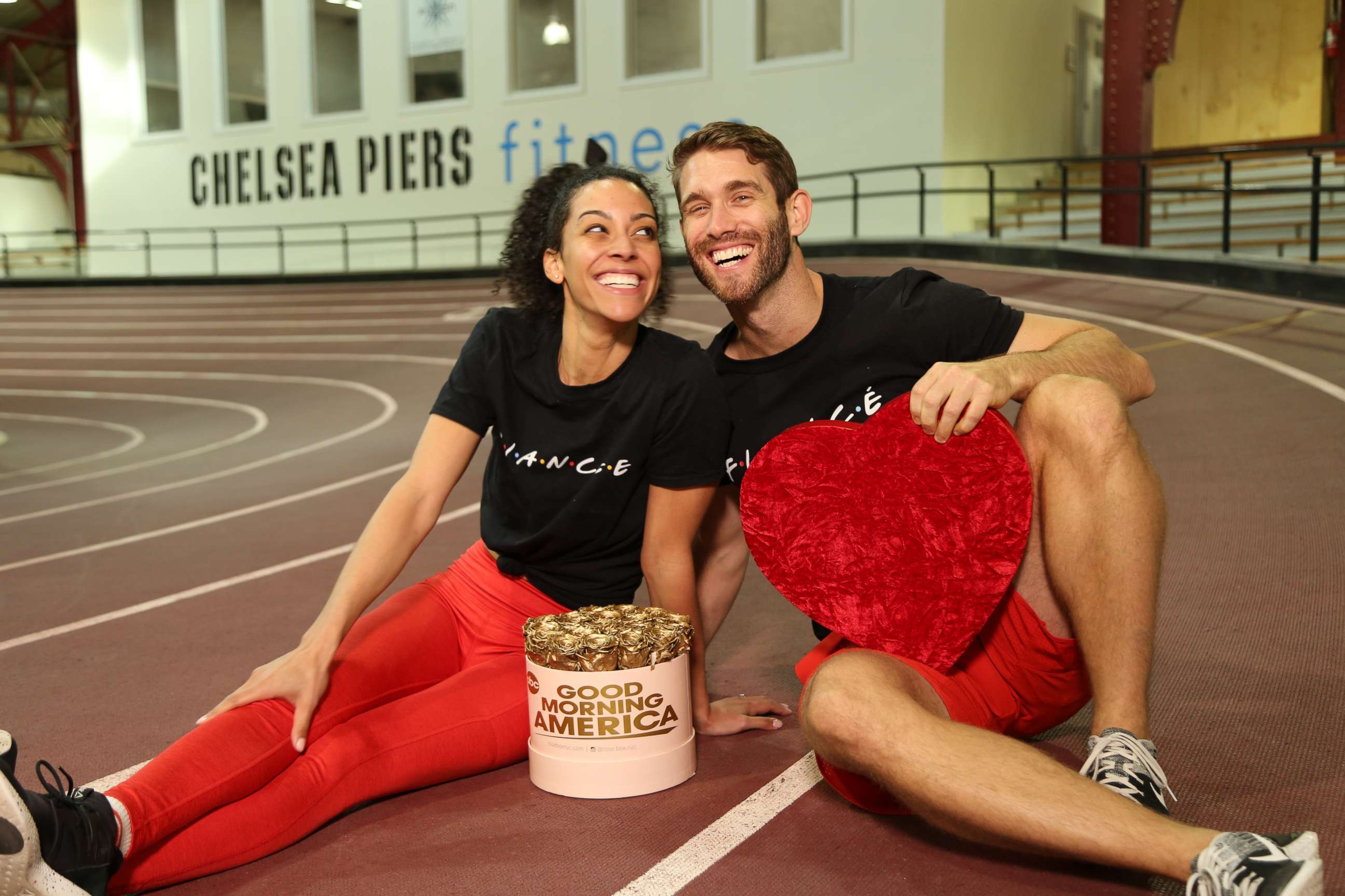 PHOTO: Engaged trainers Bree Branker and CJ Koegel demonstrate a couples workout at Chelsea Piers in New York City.