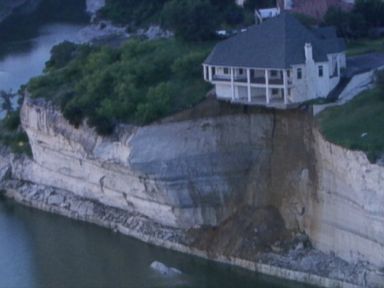 VIDEO: A portion of the Texas home has already fallen onto the shoreline of Lake Whitney.