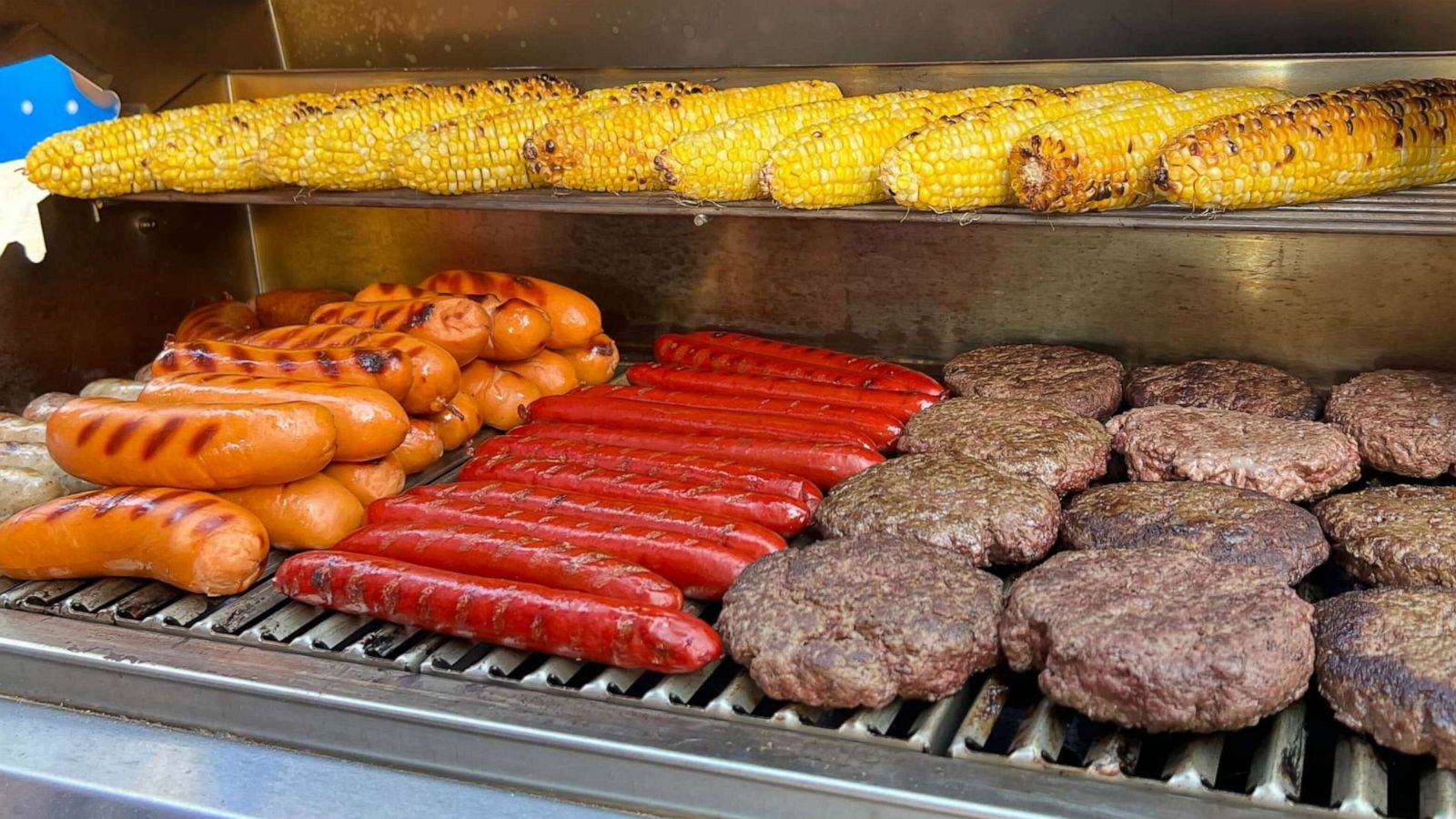 PHOTO: A grill of corn, hot dogs and burgers.