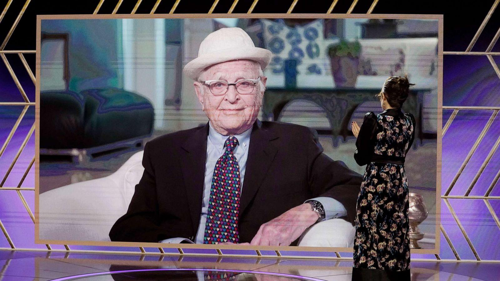 PHOTO: Honoree Norman Lear accepts the Carol Burnett Award via video while co-host Tina Fey reacts onstage at Annual Golden Globe Awards broadcast on Feb. 28, 2021.