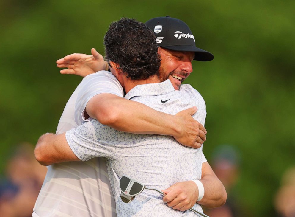 PHOTO: Michael Block, PGA of America Club Professional, and Rory McIlroy congratulate each other on the 18th green during the final round of the 2023 PGA Championship at Oak Hill Country Club on May 21, 2023 in Rochester, N.Y.