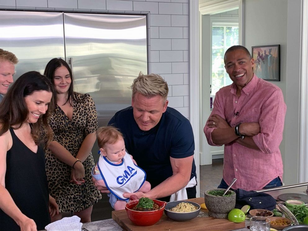 PHOTO: Chef Gordon Ramsay holds his son Oscar, alongside his wife Tana, in his kitchen after preparing a Moroccan-inspired dish.