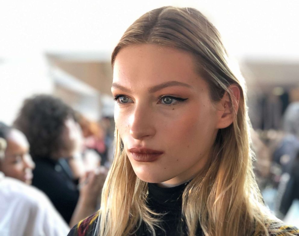 A model strikes a pose backstage before Cushnie's fall 2019 show. 