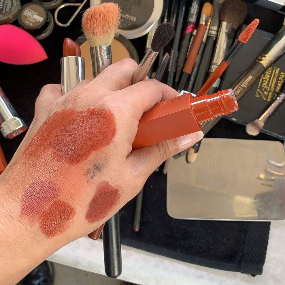 PHOTO: Grace Lee swatches products backstage before Cushnie's fall 2019 show. 