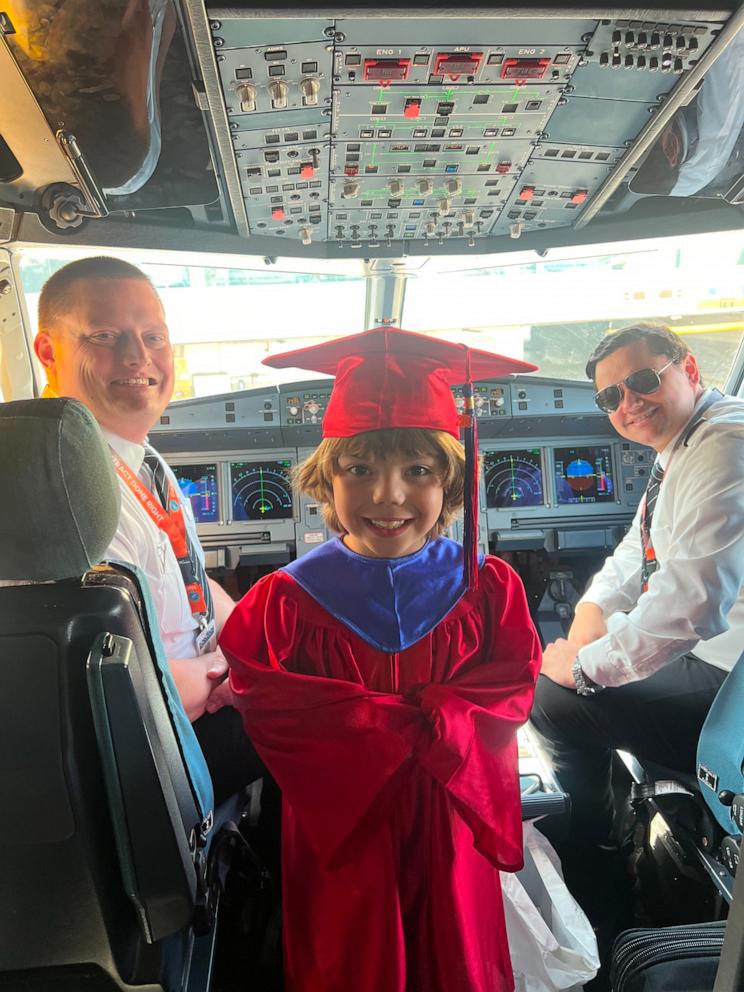 PHOTO: Xavier posed with his cap and gown for a photo with Frontier pilots.