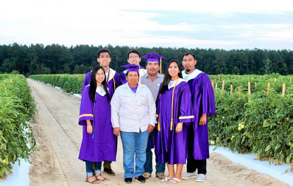 PHOTO:  Erick Martínez Juárez, 29, along with his four siblings and parents in their high school regalia at a tomato field in Decatur County, Georgia, in May 2020.