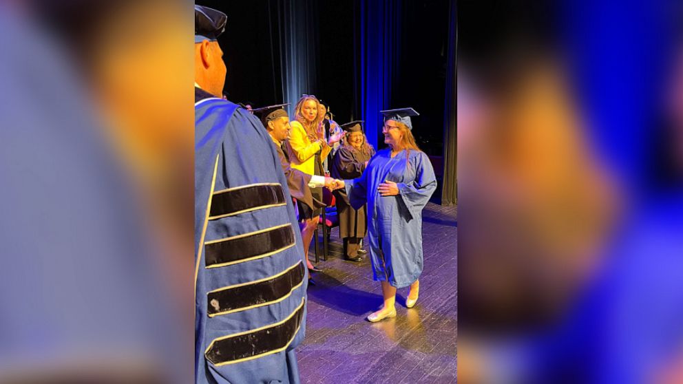 PHOTO: Kelsey Hudie holds her diploma alongside Russell Kavalhuna, the president of Henry Ford College.