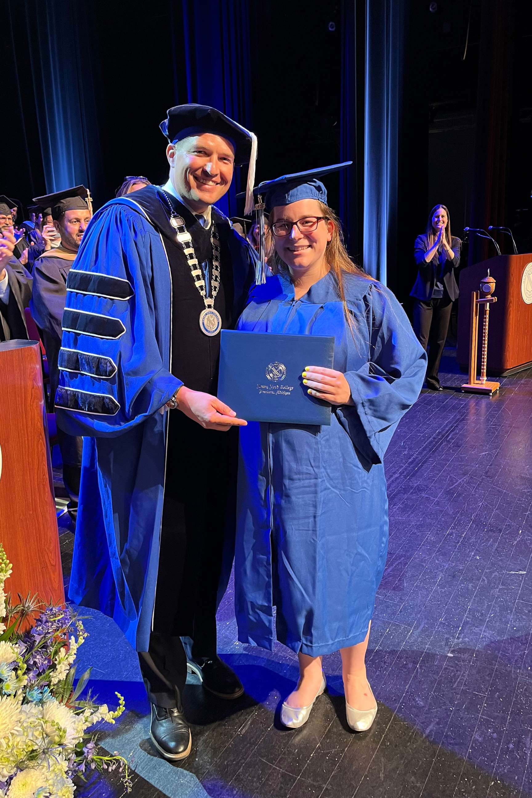 PHOTO: Kelsey Hudie walks across the stage during the May 2023 commencement ceremony at Henry Ford College in Dearborn, Michigan.