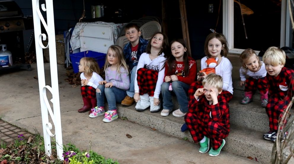 PHOTO: Amara, 10, Christian, 9, Autumn, 8, Lily, 8, Gabriel, 6, Everett, 4, Piper, 4, Emma, 4, Hero, 2 and Teddy, 2, with a small, yellow school bus on Christmas morning from their grandfather, Doug Hayes of Oregon.