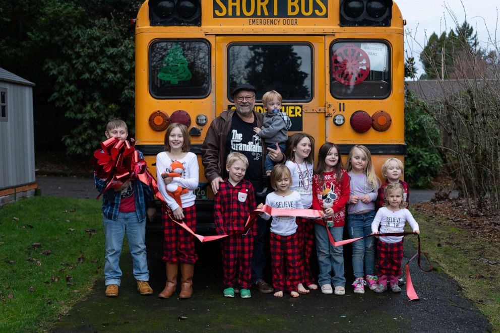 PHOTO: Doug Hayes of Grafton, Oregon, surprised Amara, 10, Christian, 9, Autumn, 8, Lily, 8, Gabriel, 6, Everett, 4, Piper, 4, Emma, 4, Hero, 2 and Teddy, 2, with a small, yellow school bus on Christmas morning.