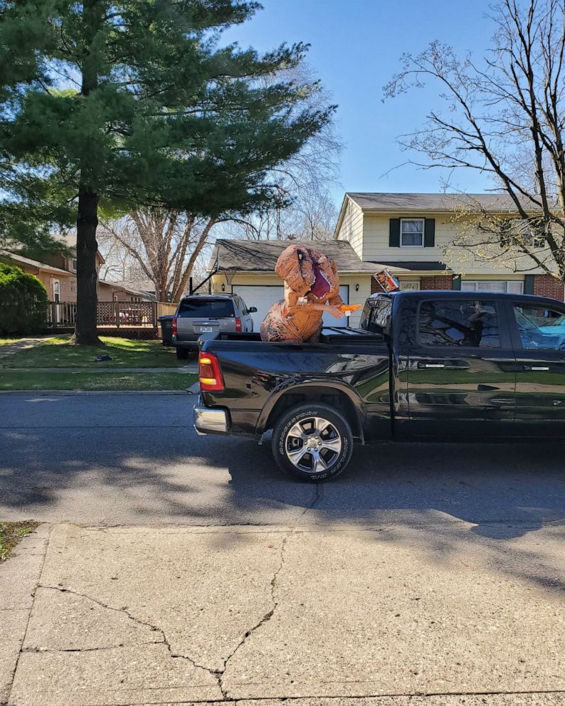 PHOTO: Murphy Stammer loved seeing family pass his home during his birthday parade in Des Moines, Iowa, especially his Aunt Lindsey who was dressed in a dinosaur costume.