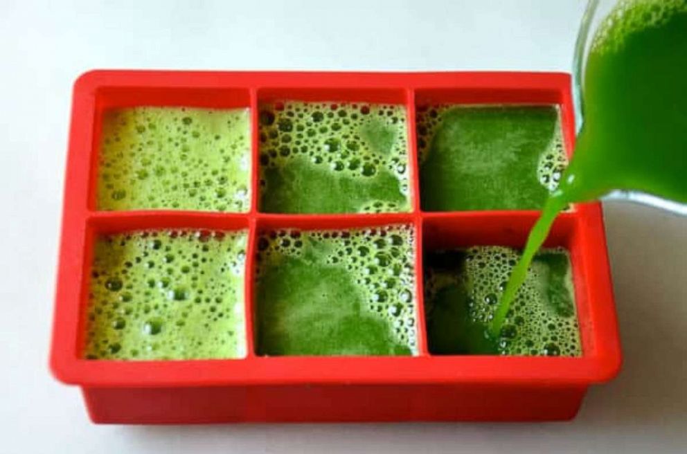 PHOTO: Blended green juice ingredients poured into large ice cube trays for popsicles.