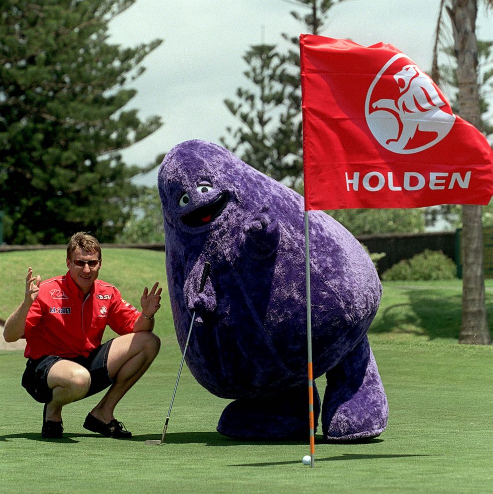 PHOTO: In this Dec. 15, 2000, file photo, race car driver Mark Skaife of Australia and Grimace of McDonalds appear at a charity event at the Tuggerah Lakes Golf Course, Tuggerah, Australia.