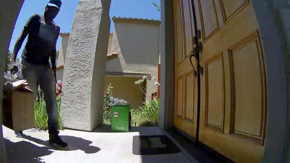 PHOTO: A delivery worker for the Amazon Fresh grocery delivery service delivers a parcel of groceries to a suburban home in San Ramon, Calif., July 26, 2017.