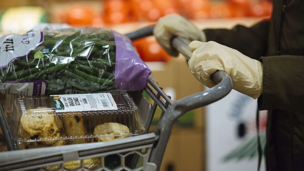 PHOTO: A customer wearing gloves shops at a Stew Leonard's supermarket in Paramus, N.J., May 12, 2020.