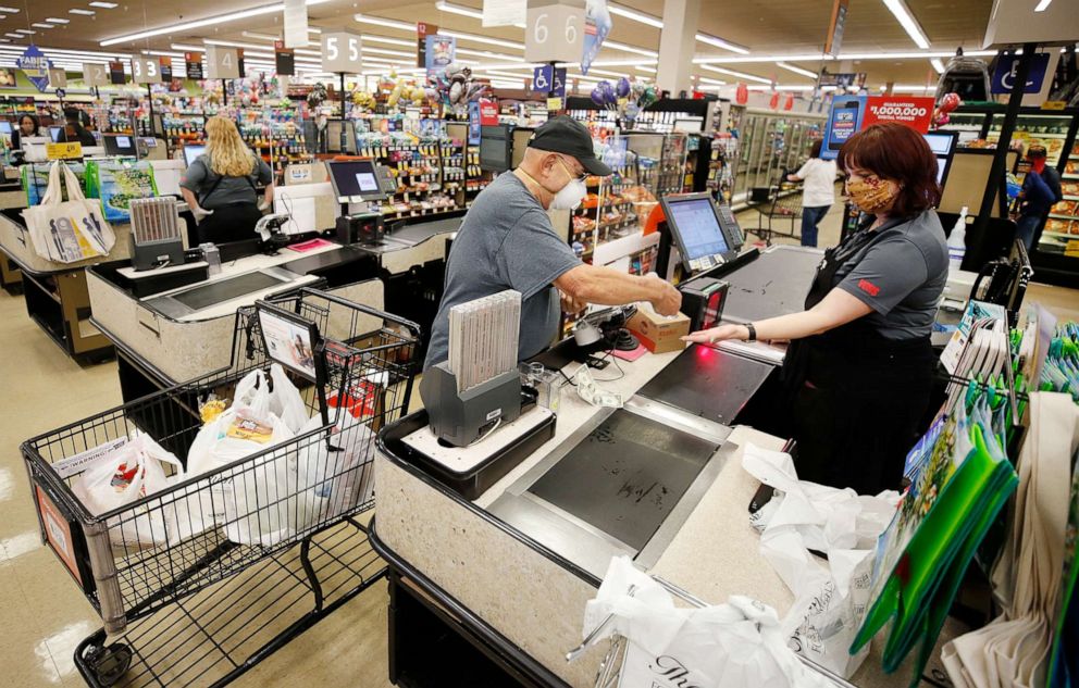 PHOTO: A cashier at Vons checks out a customer at a store in Torrance, Calif., April 27, 2020.