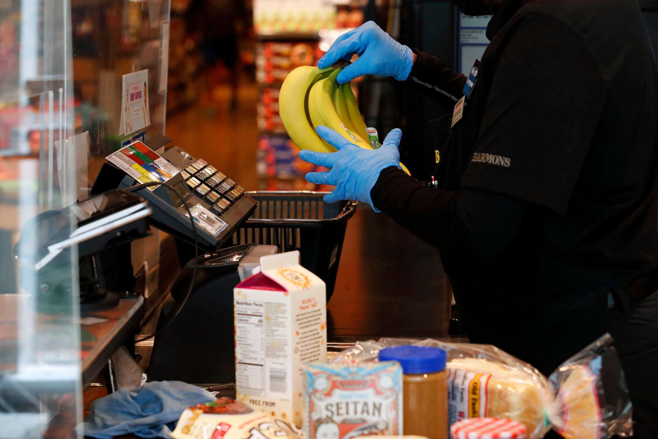 PHOTO: FILE - A cashier works at a checkout counter at Harmons Grocery store in Salt Lake City, Utah, Oct. 21, 2021.
