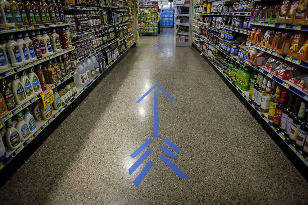 PHOTO: A tape arrow indicates the direction of travel at a grocery store in Chicago, May 7, 2020.