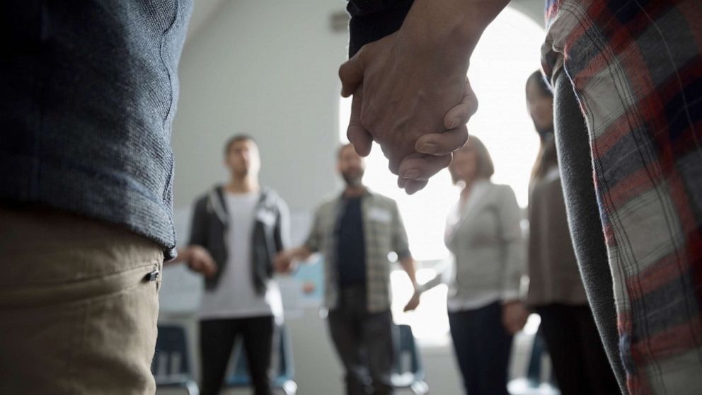 PHOTO: An undated stock photo shows a group of people holding hands in a circle.