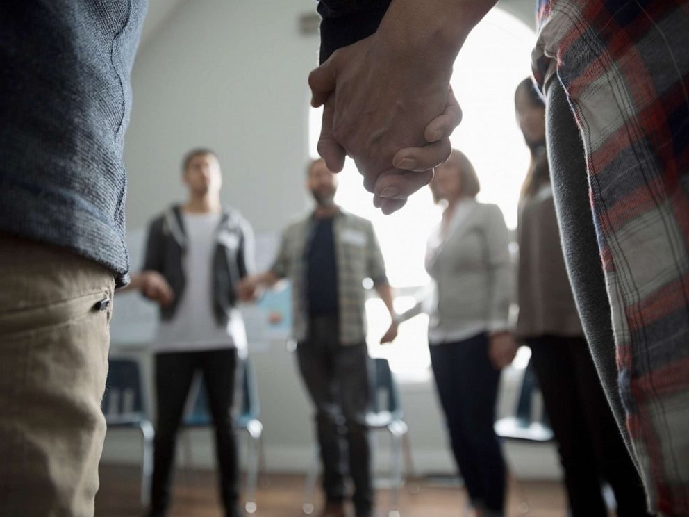 PHOTO: An undated stock photo shows a group of people holding hands in a circle.