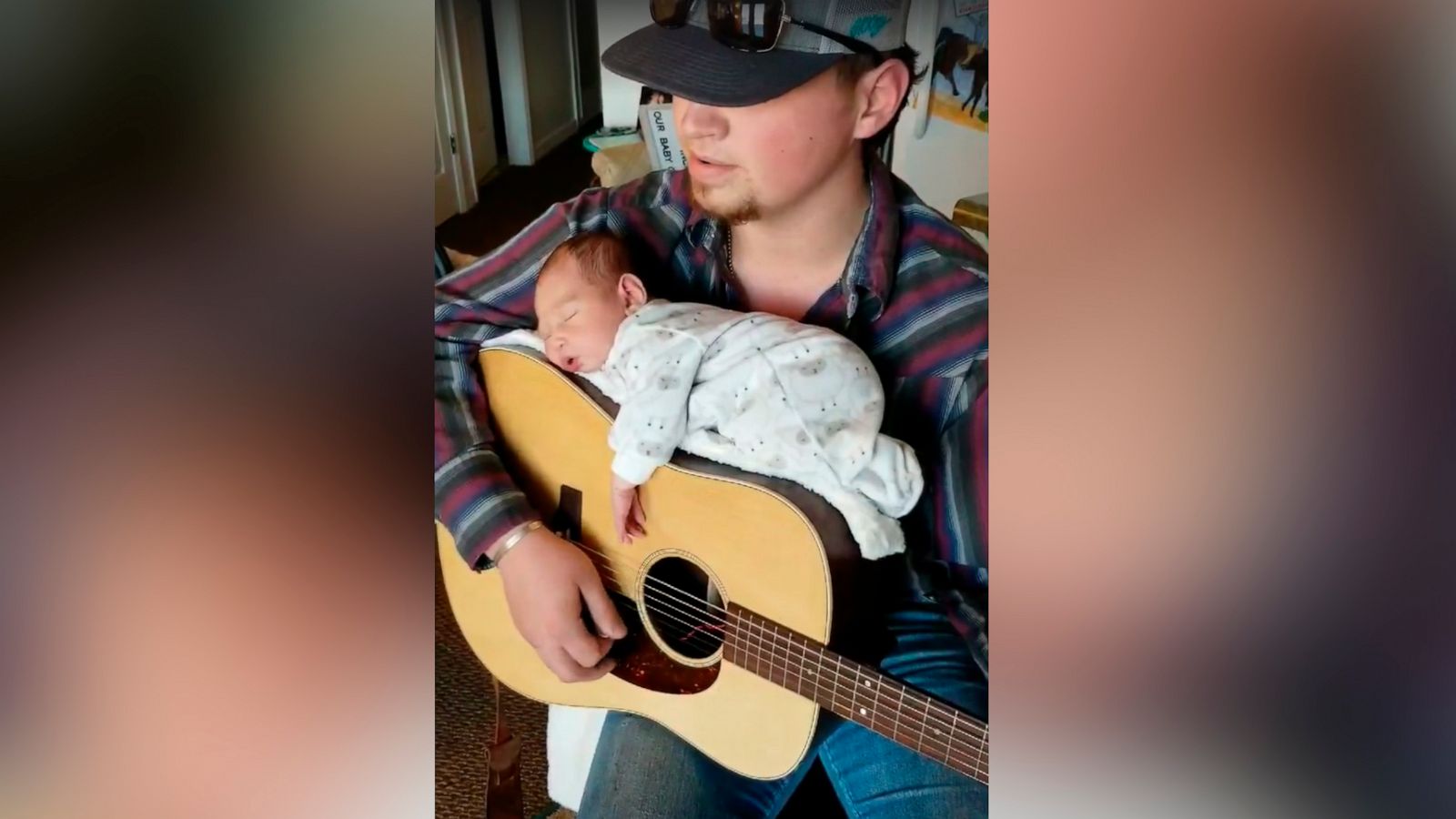 PHOTO: Cody Comer, 21, used his guitar to lull his daughter, Carrigan, to sleep.