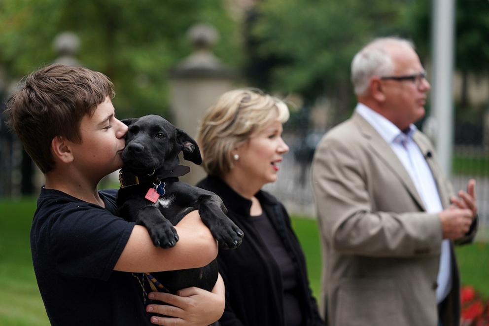 PHOTO: In this Sept. 5, 2019, file photo, Gus Walz, left, holds Scout, a 3-month-old Labrador Retriever the Walz family adopted, during a news conference to announce the family's newest addition at the governor's residence.