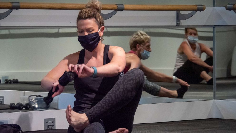 PHOTO: A woman prepares for her workout at Pure Barre Cincinnati West as Ohio gyms and fitness centers reopen for business in the wake of the Coronavirus COVID-19 pandemic, on May 26, 2020, in Cincinnati.