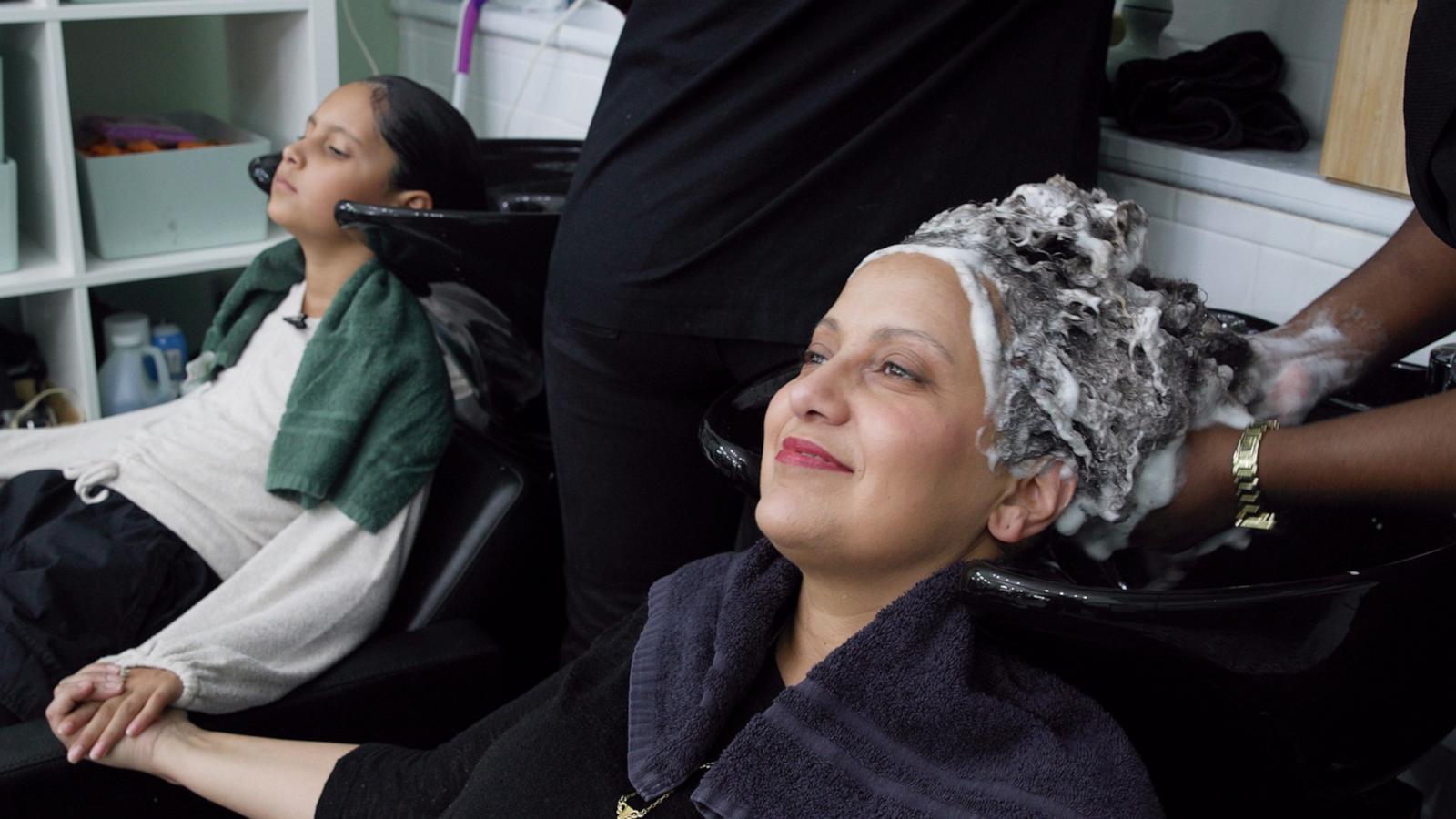 PHOTO: Miguelina German and her daughter, Ariela Mercado, get their hair washed.