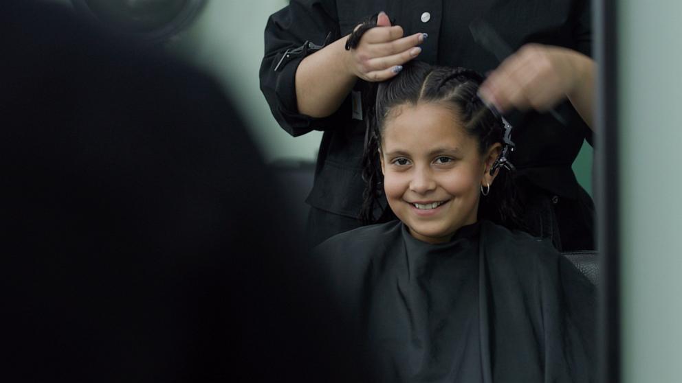 PHOTO: Ariela Mercado, 10, smiles while getting her hair braided.