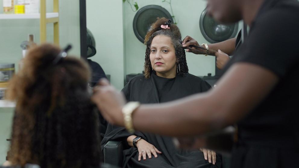 PHOTO: Miguelina Herman getting hair styled.