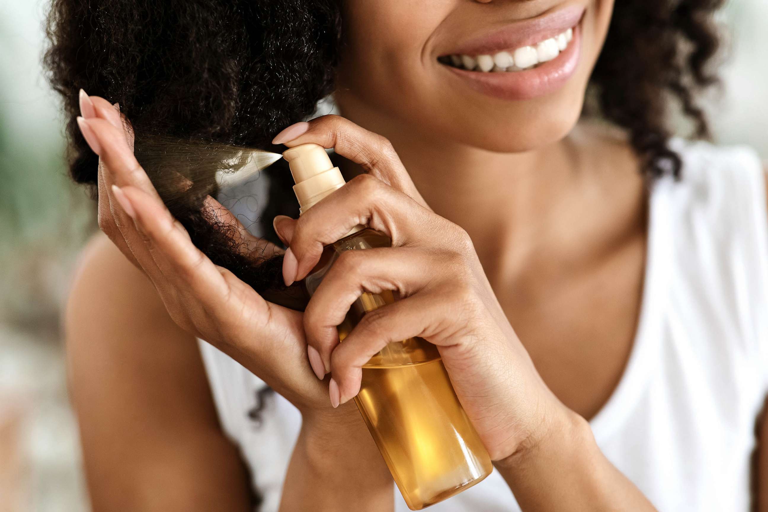 PHOTO: STOCK PHOTO: A woman applies hairspray caring product