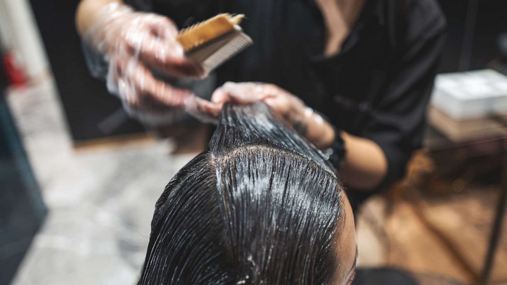 PHOTO: In an undated stock photo, a woman is seen getting her hair straightened in a salon.