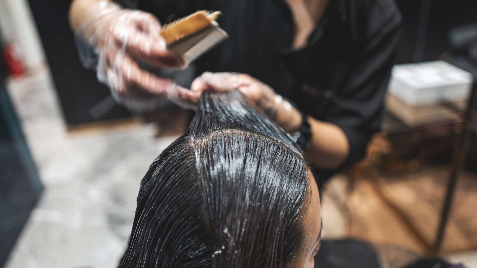 PHOTO: In an undated stock photo, a woman is seen getting her hair straightened in a salon.