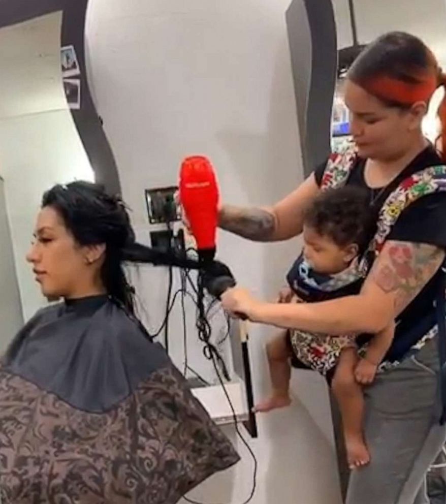 PHOTO: Maria Khachotamraz took care of her longtime friend Jessica at the salon on Sept. 25 while her 9-month-old daughter Camila was strapped to her chest.