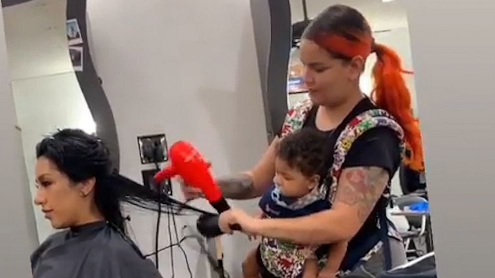 PHOTO: Maria Khachotamraz took care of her longtime friend Jessica at the salon on Sept. 25 while her 9-month-old daughter Camila was strapped to her chest.