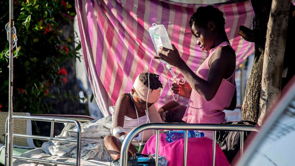 PHOTO: A boy is tended to outside Les Cayes General Hospital after a 7.2-magnitude earthquake on Aug. 15, 2021 in Les Cayes, Haiti. Rescue workers have been working among destroyed homes since the quake struck on Saturday.