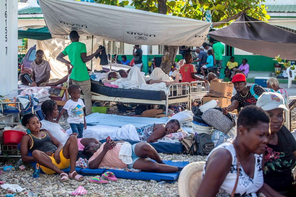 PHOTO: Haitians rest outdoors after a 7.2-magnitude earthquake on Aug. 15, 2021 in Les Cayes, Haiti. Rescue workers have been working among destroyed homes since the quake struck on Saturday.