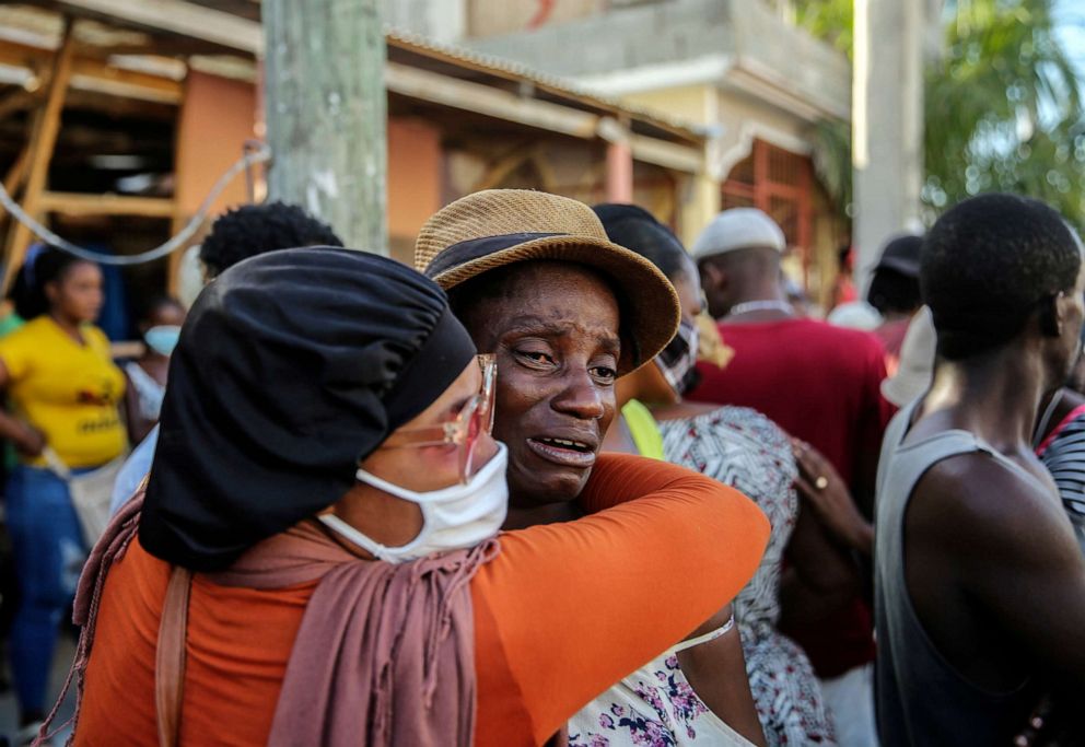PHOTO: People cry during the search for those who are still missing in a house destroyed by the earthquake in Les Cayes, Haiti, Sunday, Aug. 15, 2021.