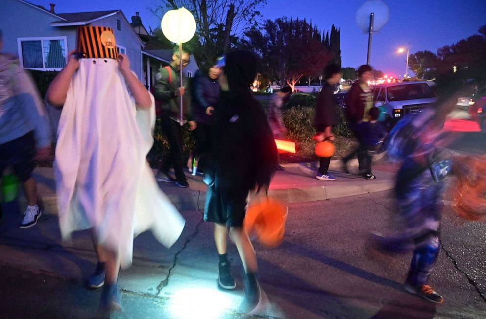 PHOTO: Children go trick or treating on Halloween night in Monterey Park, Calif., Oct. 31, 2019. 