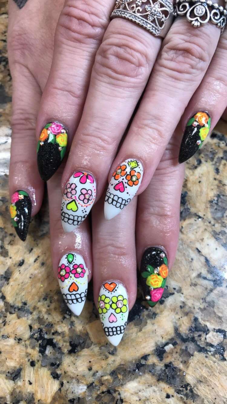 PHOTO: She painted Day of the Dead sugar skills on this woman's nails.