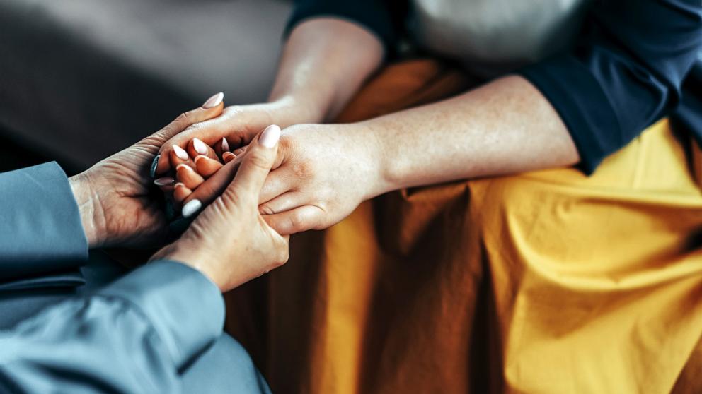 PHOTO: Stock photo of two women holding hands.