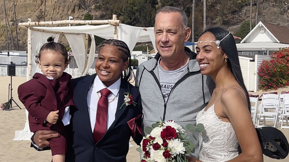 PHOTO: Actor Tom Hanks stopped to take photos with Diciembre and Tashia Farries in Santa Monica after their ceremony on the beach.