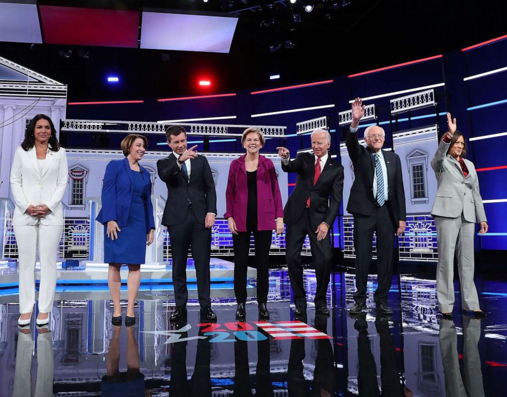 PHOTO: Democratic presidential candidates arrive on stage before the start of the Democratic Presidential Debate at Tyler Perry Studios, Nov. 20, 2019, in Atlanta.