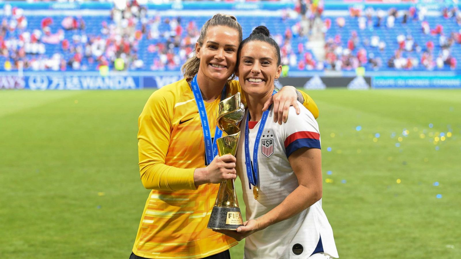 PHOTO: Ashlyn Harris, left, and Ali Krieger pose with the World Cup after the 2019 FIFA Women's World Cup France final match between the Netherlands and the United States at Stade de Lyon on July 07, 2019, in Lyon, France.