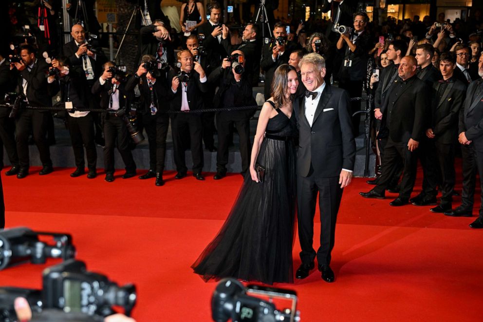 PHOTO: Calista Flockhart and Harrison Ford depart the "Indiana Jones And The Dial Of Destiny" red carpet during the 76th annual Cannes film festival at Palais des Festivals, May 18, 2023, in Cannes, France.