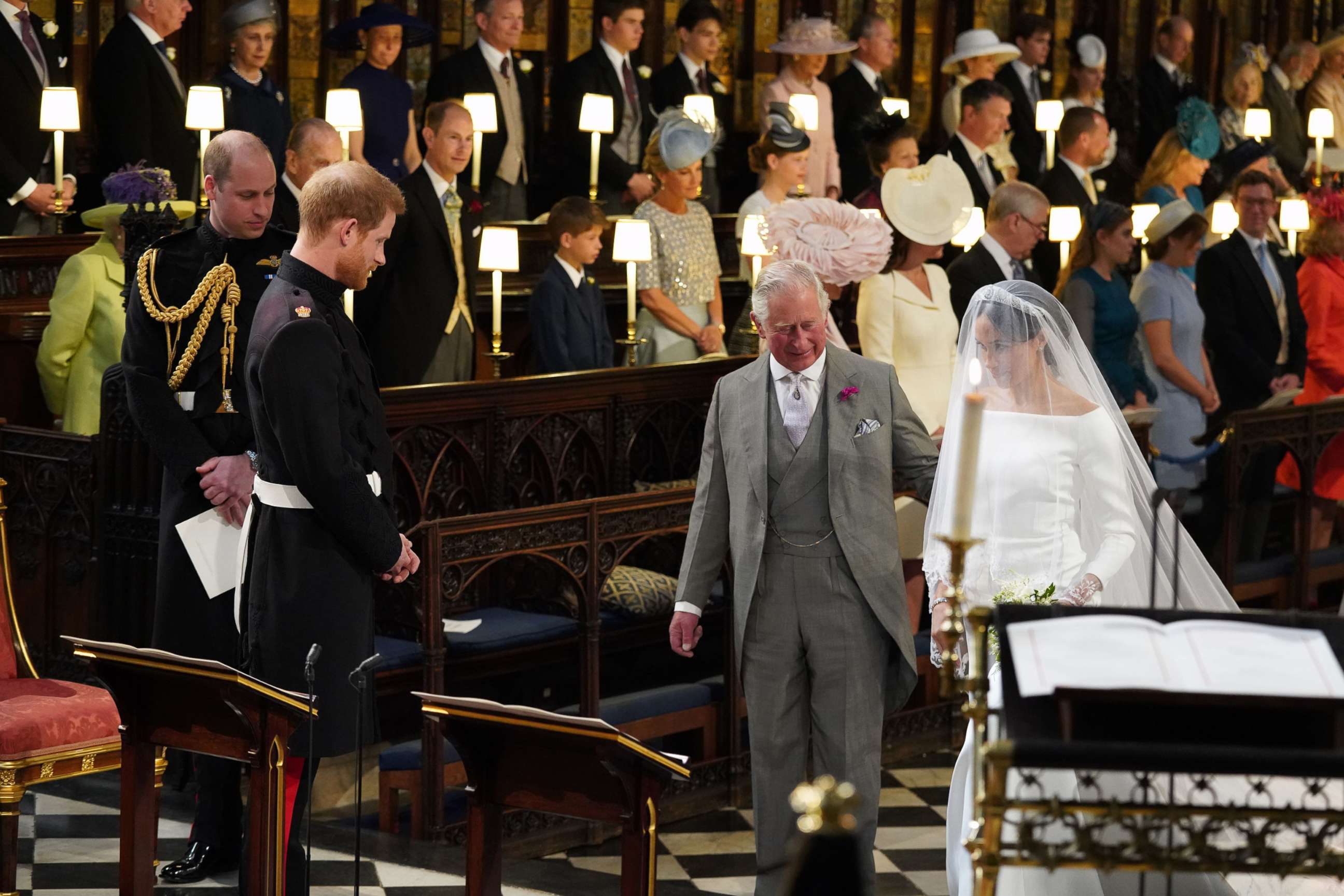 PHOTO: Britain's Prince Harry looks at his bride, Meghan Markle, as she arrives accompanied by the Britain's Prince Charles in St George's Chapel during their wedding ceremony in St George's Chapel, Windsor Castle, in Windsor, May 19, 2018.