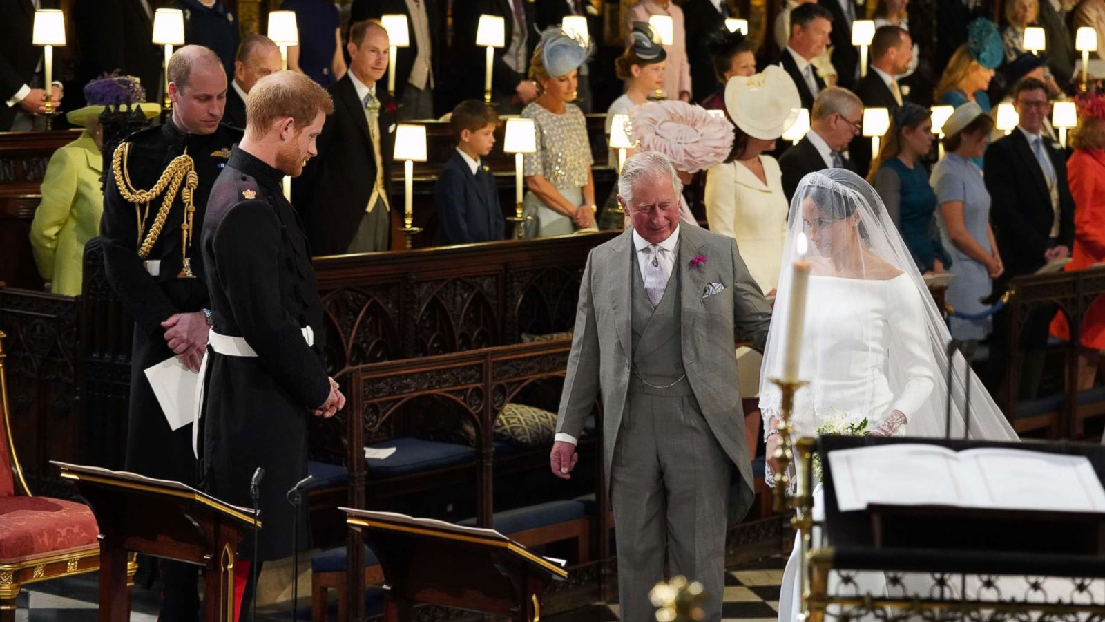 PHOTO: Britain's Prince Harry looks at his bride, Meghan Markle, as she arrives accompanied by the Britain's Prince Charles in St George's Chapel during their wedding ceremony in St George's Chapel, Windsor Castle, in Windsor, May 19, 2018.